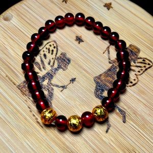 Red and gold beads bracelets that stretches over your wrist.